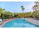Inviting community pool with lounge chairs and lush tropical landscaping, perfect for relaxation at 9620 Doris Ln, Orlando, FL 32829