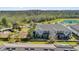 Aerial view of townhomes, playground, and scenic pond, showcasing the community's amenities at 10316 Spring Arbor Ln, Winter Garden, FL 34787