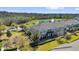 This aerial view highlights townhomes near a pond with a fountain, a playground, and green spaces for outdoor activities at 10316 Spring Arbor Ln, Winter Garden, FL 34787