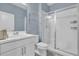 Clean bathroom featuring a glass-enclosed shower, white vanity, and modern fixtures at 10316 Spring Arbor Ln, Winter Garden, FL 34787