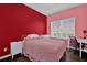 Bedroom with accent wall, a queen-sized bed, and a well-lit desk area at 10316 Spring Arbor Ln, Winter Garden, FL 34787