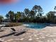 Community pool surrounded by lounge chairs and lush landscaping, perfect for relaxation and enjoying the outdoors at 10316 Spring Arbor Ln, Winter Garden, FL 34787