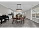 Open dining area with modern chandelier, tile floors, and access to the kitchen at 10316 Spring Arbor Ln, Winter Garden, FL 34787