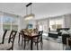 Dining area with a chandelier above a wood table and a decorative rug at 10316 Spring Arbor Ln, Winter Garden, FL 34787