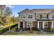 Two-story townhome with neat landscaping, a brick pathway, and neutral color palette at 10316 Spring Arbor Ln, Winter Garden, FL 34787