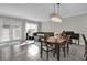 Open-concept living room with large windows, a chandelier, and tile floors at 10316 Spring Arbor Ln, Winter Garden, FL 34787