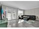 Living room features tile floors and a dark sectional at 10316 Spring Arbor Ln, Winter Garden, FL 34787