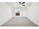 Carpeted bedroom featuring ceiling fan and view into bathroom at 1042 Catfish Creek Ct, Oviedo, FL 32765