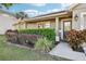 Inviting front entrance with lush landscaping, window detail, and stylish exterior lighting at 1042 Catfish Creek Ct, Oviedo, FL 32765