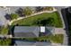 High-angle aerial view of home highlighting roof, screened enclosure, and green landscaping at 11880 Sonnet Ave, Orlando, FL 32832