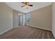 Spacious bedroom with a ceiling fan and a window with natural light and neutral carpet at 11880 Sonnet Ave, Orlando, FL 32832