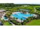 Expansive community pool area featuring tropical landscaping, splash pad and lounge seating at 11880 Sonnet Ave, Orlando, FL 32832