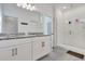 Bright bathroom featuring double vanity, granite countertops, and a glass-enclosed shower at 1232 Celery Oaks Ln, Sanford, FL 32771