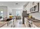 Modern kitchen featuring granite countertops, stainless steel appliances, and bright white cabinets at 1232 Celery Oaks Ln, Sanford, FL 32771