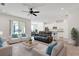 Open-concept living room with modern decor and a view into the kitchen and dining area at 1232 Celery Oaks Ln, Sanford, FL 32771