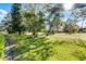 Sprawling backyard with lush green grass, mature trees, and views of the surrounding neighborhood at 139 Durham Pl, Longwood, FL 32779