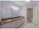 Bathroom featuring double sinks, framed mirrors and decorative flooring in front of the walk in shower at 139 Durham Pl, Longwood, FL 32779