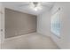 Bedroom with neutral carpet, ceiling fan, and a window offering plenty of natural light at 139 Durham Pl, Longwood, FL 32779