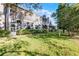 Exterior view of the condo buildings with screened patios, complemented by a well-maintained lawn and greenery at 139 Durham Pl, Longwood, FL 32779