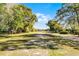 Expansive green space surrounded by mature trees, offering a serene and natural environment at 139 Durham Pl, Longwood, FL 32779