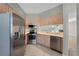 Well-lit kitchen with tile floors, stainless steel appliances, and light wood cabinetry at 139 Durham Pl, Longwood, FL 32779