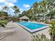 Large community pool surrounded by lounge chairs and lush landscaping at 139 Durham Pl, Longwood, FL 32779