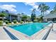 Community pool with lounge chairs, sunbathing area, clubhouse, and lush landscaping at residential community at 139 Durham Pl, Longwood, FL 32779