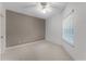 Bright bedroom featuring a neutral color palette, a ceiling fan, and a large window at 139 Durham Pl, Longwood, FL 32779