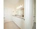 Bathroom featuring dual sinks with granite countertops, tile flooring, and modern lighting fixtures at 1447 Kissimmee Way, Kissimmee, FL 34759