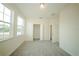 Bright bedroom featuring plush carpeting, two windows, and a closet at 1447 Kissimmee Way, Kissimmee, FL 34759