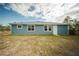 Rear exterior view of a blue sided single-Gathering home at 1447 Kissimmee Way, Kissimmee, FL 34759