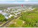 Aerial view of the property indicated by a red arrow, near a lake and golf course at 1468 Fairview Cir, Reunion, FL 34747