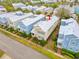 Aerial view of a charming two-story home with a metal roof, colorful siding, and well-maintained landscaping at 1468 Fairview Cir, Reunion, FL 34747