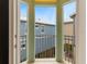 Balcony view with metal railings and view of neighboring houses with blue skies at 1468 Fairview Cir, Reunion, FL 34747