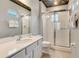 Bathroom with a white vanity, toilet, framed mirror, and glass enclosed shower featuring tile walls and silver fixtures at 1468 Fairview Cir, Reunion, FL 34747