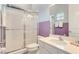 Bright bathroom featuring tiled shower, quartz countertops, and vanity with white cabinets at 1468 Fairview Cir, Reunion, FL 34747