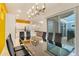 Bright dining room featuring a modern chandelier and sliding glass doors to the patio at 1468 Fairview Cir, Reunion, FL 34747