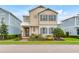 Charming two-story home with blue shutters, beige siding, and a well-maintained front lawn at 1468 Fairview Cir, Reunion, FL 34747