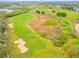 Aerial view of lush green golf course with sand traps, water hazards, and manicured fairways near the resort at 1468 Fairview Cir, Reunion, FL 34747