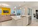 Contemporary kitchen island with seating, open to the living area and featuring modern pendant lights at 1468 Fairview Cir, Reunion, FL 34747