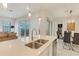 Bright kitchen island with a sink and dishwasher, seamlessly connects to the dining and living areas at 1468 Fairview Cir, Reunion, FL 34747