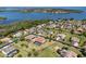 Aerial view of homes in a lakeside community, showcasing well-manicured lawns and a screened-in pool at 14823 Borromini St, Montverde, FL 34756