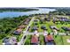 Aerial view showcases a residential neighborhood near a serene lake, with lush greenery and well-kept lawns at 14823 Borromini St, Montverde, FL 34756