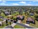 Aerial view showcasing a two-story home with a large lot outlined in red and manicured landscaping at 14823 Borromini St, Montverde, FL 34756