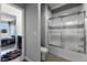 Bathroom with tiled shower and a view into the adjacent bedroom at 14823 Borromini St, Montverde, FL 34756