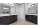 Double vanity bathroom with dark wood cabinets and a view of the backyard at 14823 Borromini St, Montverde, FL 34756