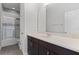 Bathroom vanity features dark cabinetry, a neutral countertop, and tub/shower combo at 14823 Borromini St, Montverde, FL 34756