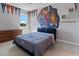 Sports themed bedroom with a basketball mural above the headboard and decorative sports pennants hanging near the ceiling at 14823 Borromini St, Montverde, FL 34756