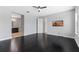 Well-lit bedroom with gleaming dark wood floors, ceiling fan, and ensuite bathroom at 14823 Borromini St, Montverde, FL 34756