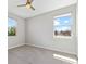 Neutral bedroom with carpet, two large windows providing neighborhood views, and a ceiling fan at 14823 Borromini St, Montverde, FL 34756